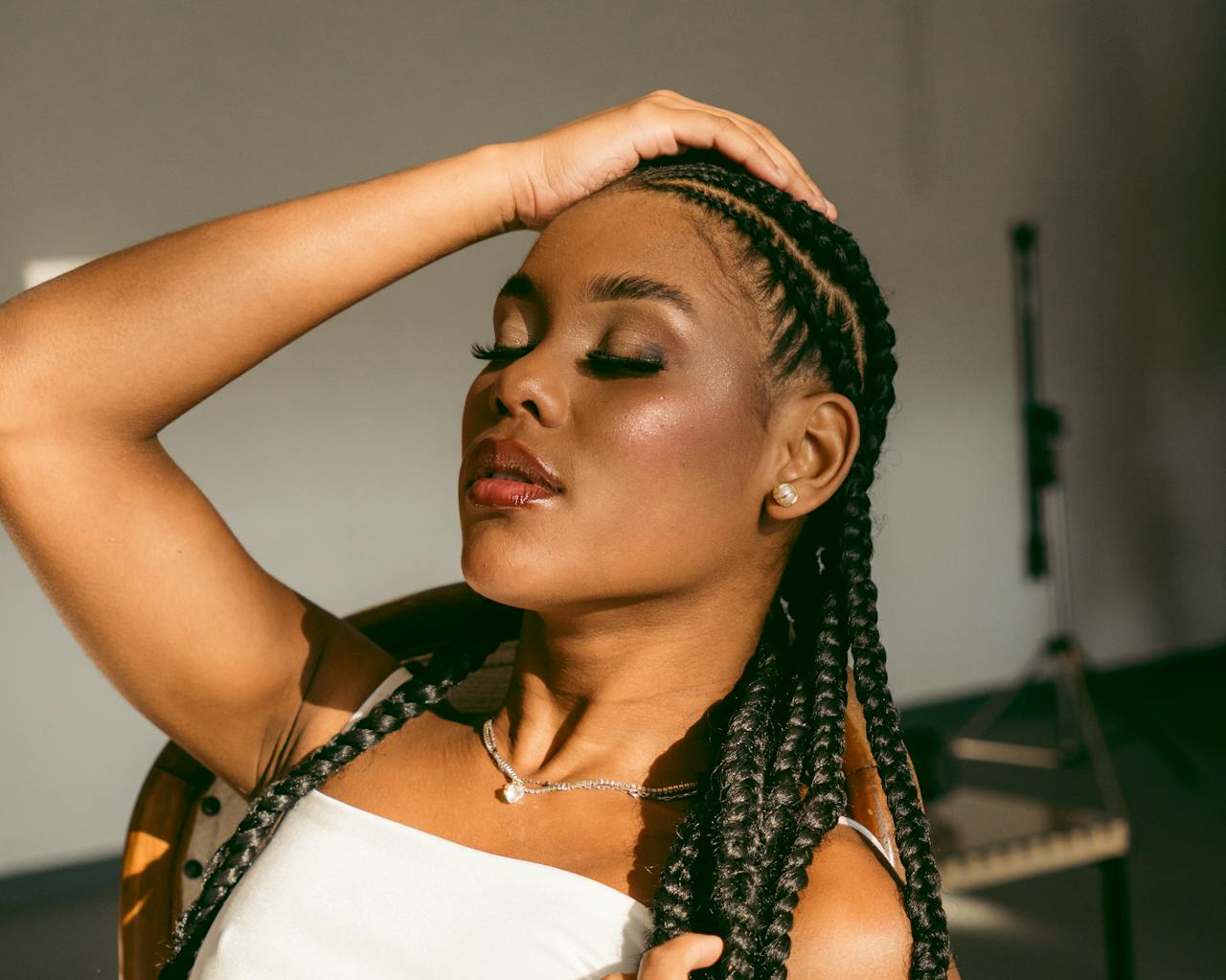Master braider at work on professional and intricate African hair braiding style